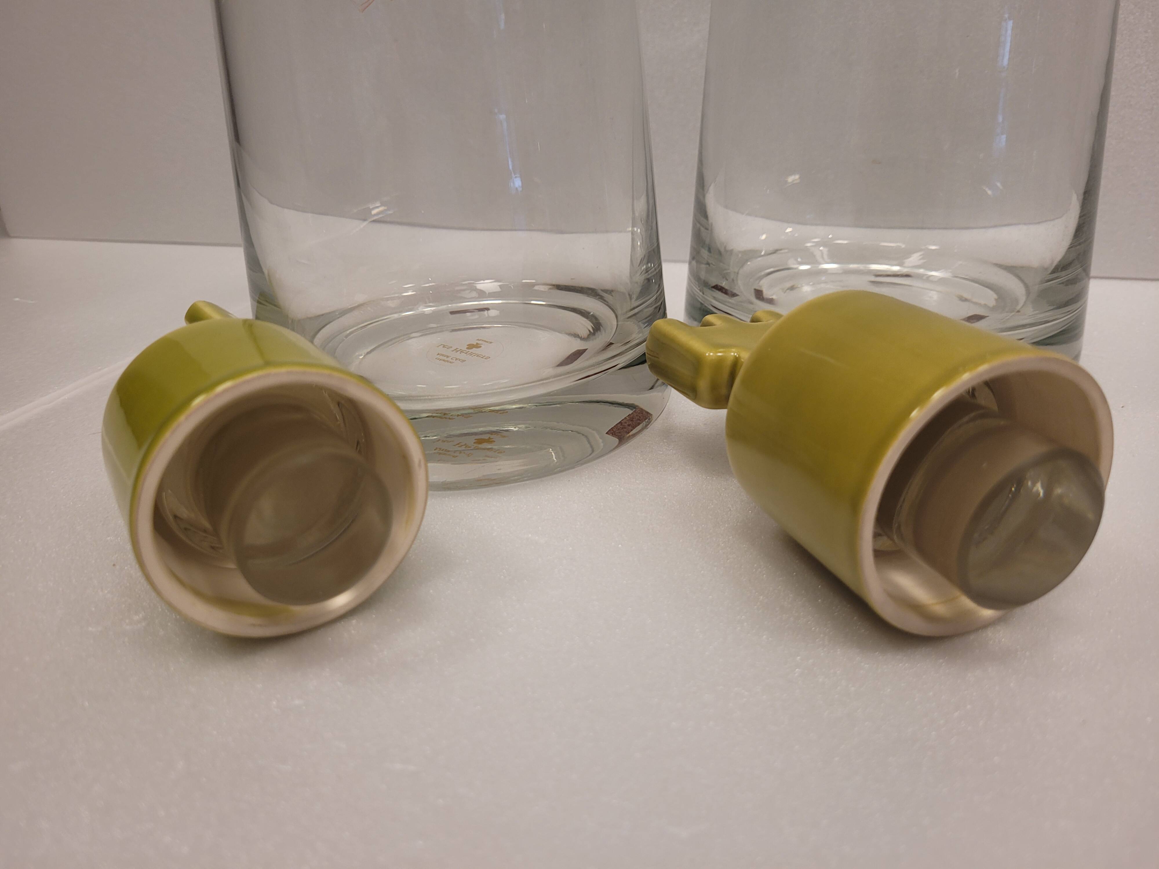 pair of decanters, bottles or jars, made in crystal with a ceramic tap enameled in green color