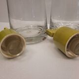 pair of decanters, bottles or jars, made in crystal with a ceramic tap enameled in green color