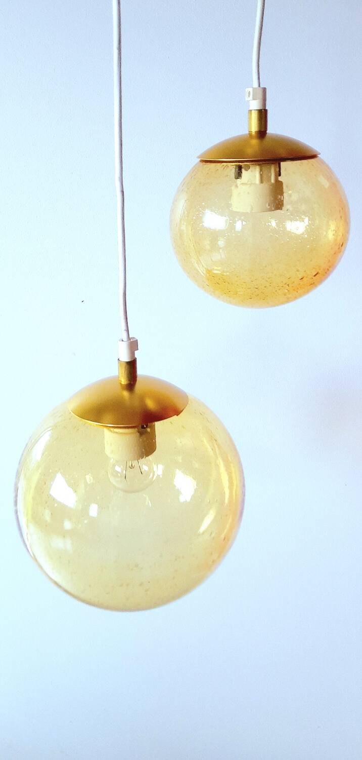 Set of 2 bubbled amber glass globe pendants