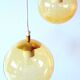 Set of 2 bubbled amber glass globe pendants