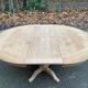 Round extendable dining table with a central pedestal base, renovated in raw wood, 150cm