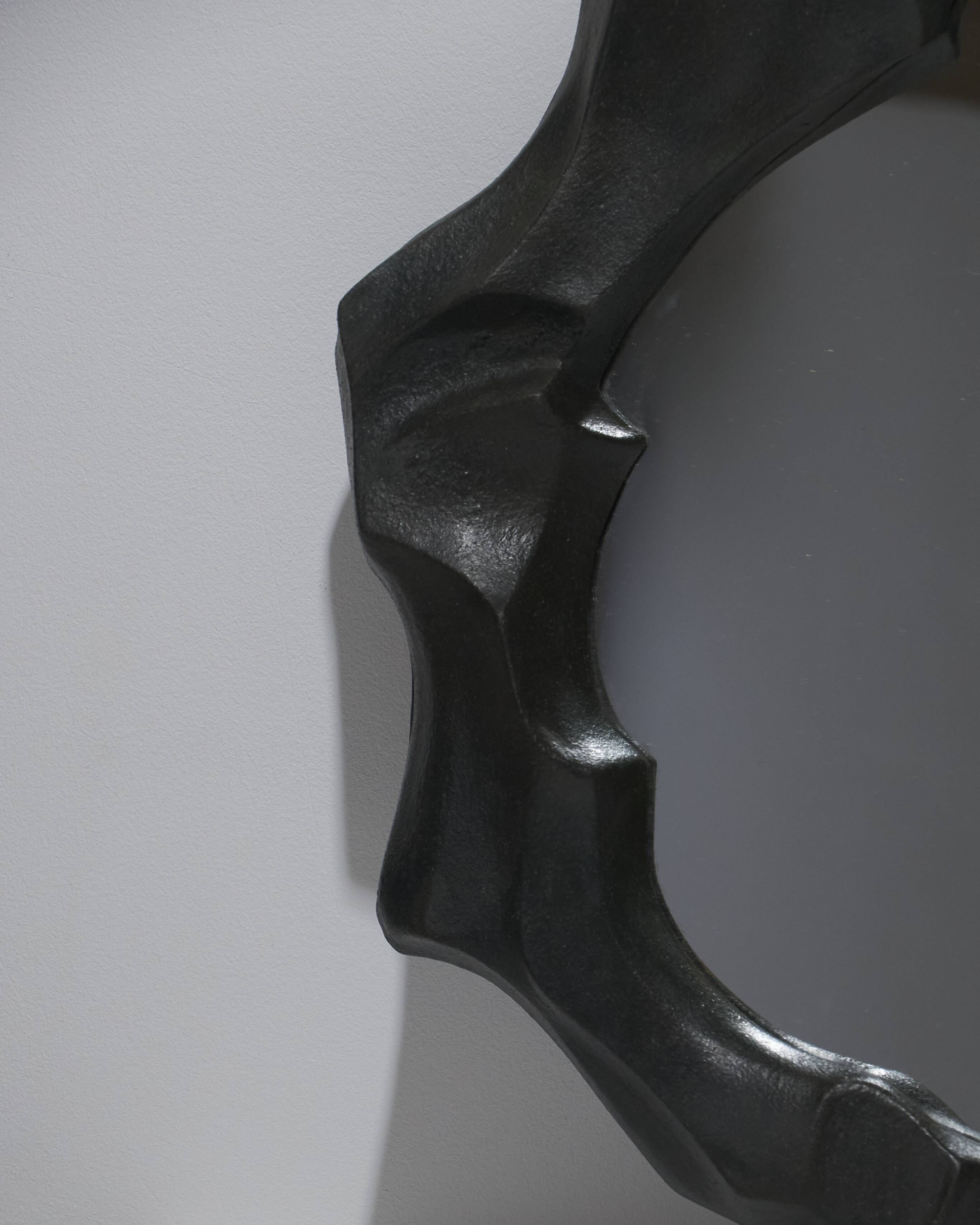 Sculptural sandstone mirror