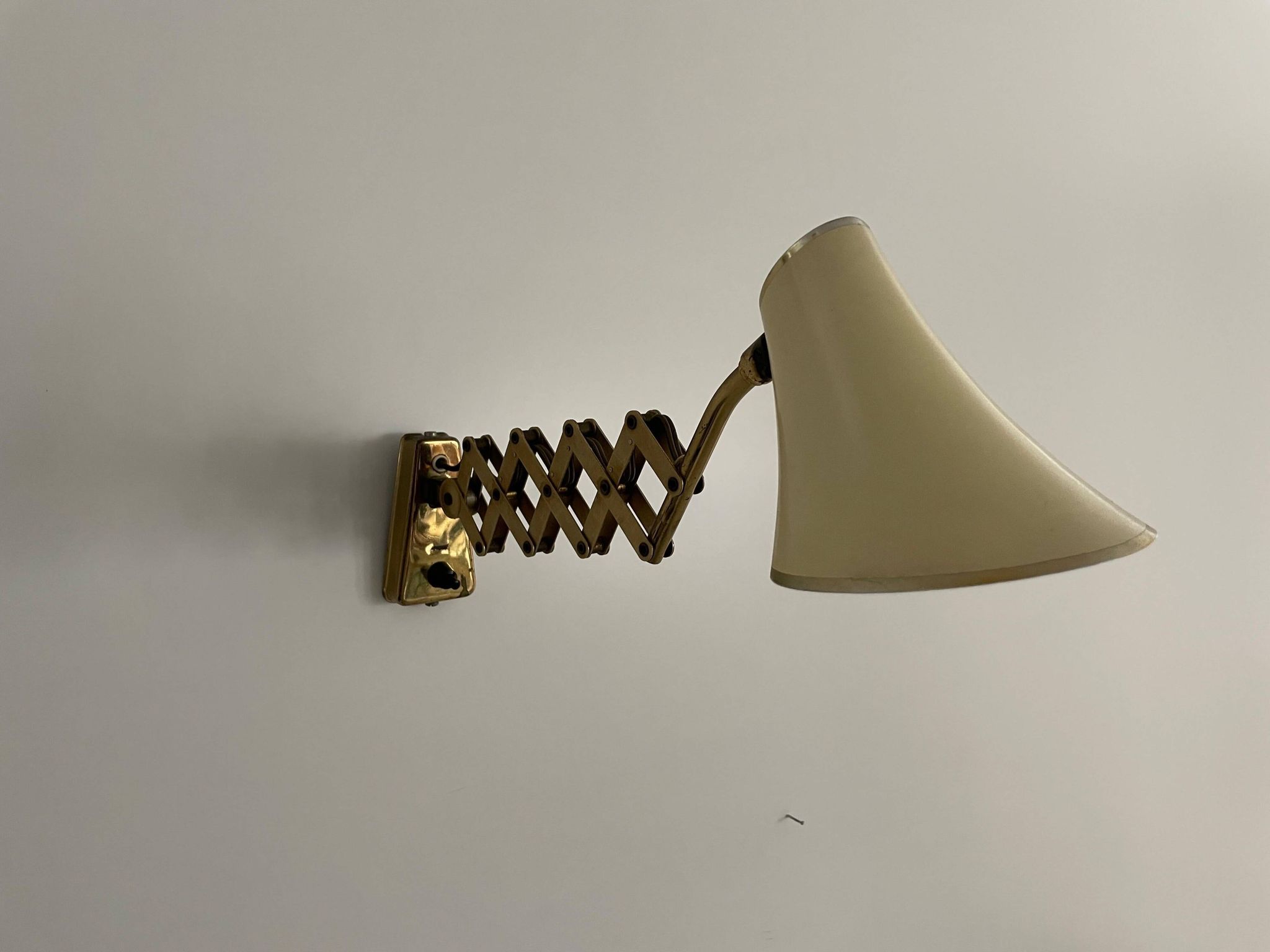 Cream metal and brass wall lamp with scissors design by Karl Lang for SIS Licht, 1950s, Germany.