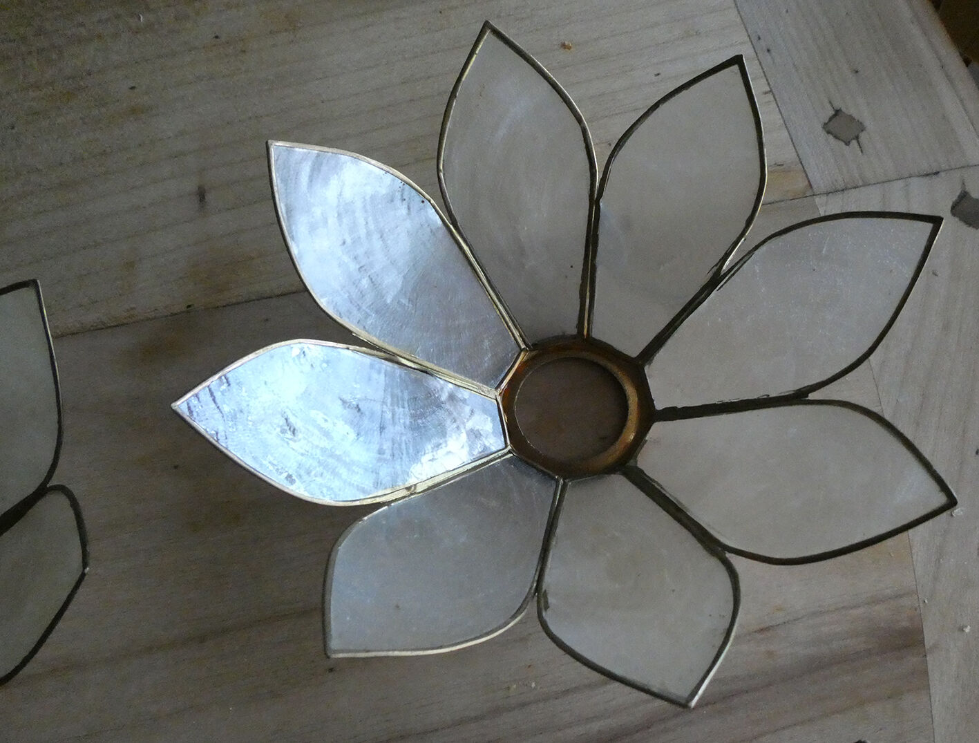 Brass chandelier and flowers in mother-of-pearl petals