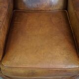 Characteristic antique sheepskin leather armchair with beautiful details and a unique design