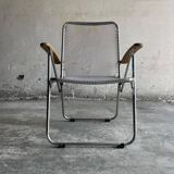Pair of vintage silver aluminum wire folding chairs with wooden armrests — industrial minimalist
