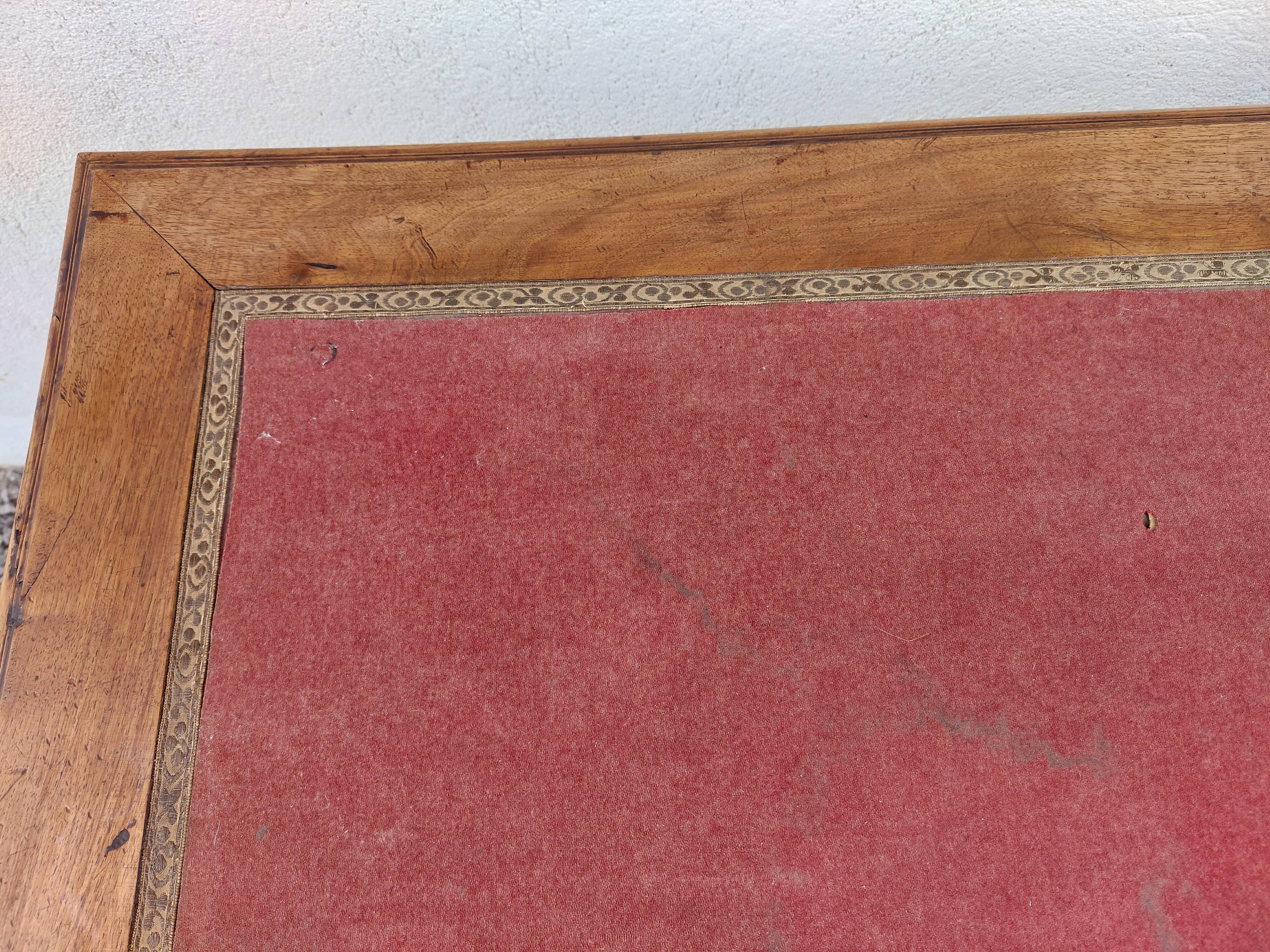 Old wooden desk, red felt top