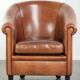 Vintage sheepskin club armchair with a warm colour scheme with black piping