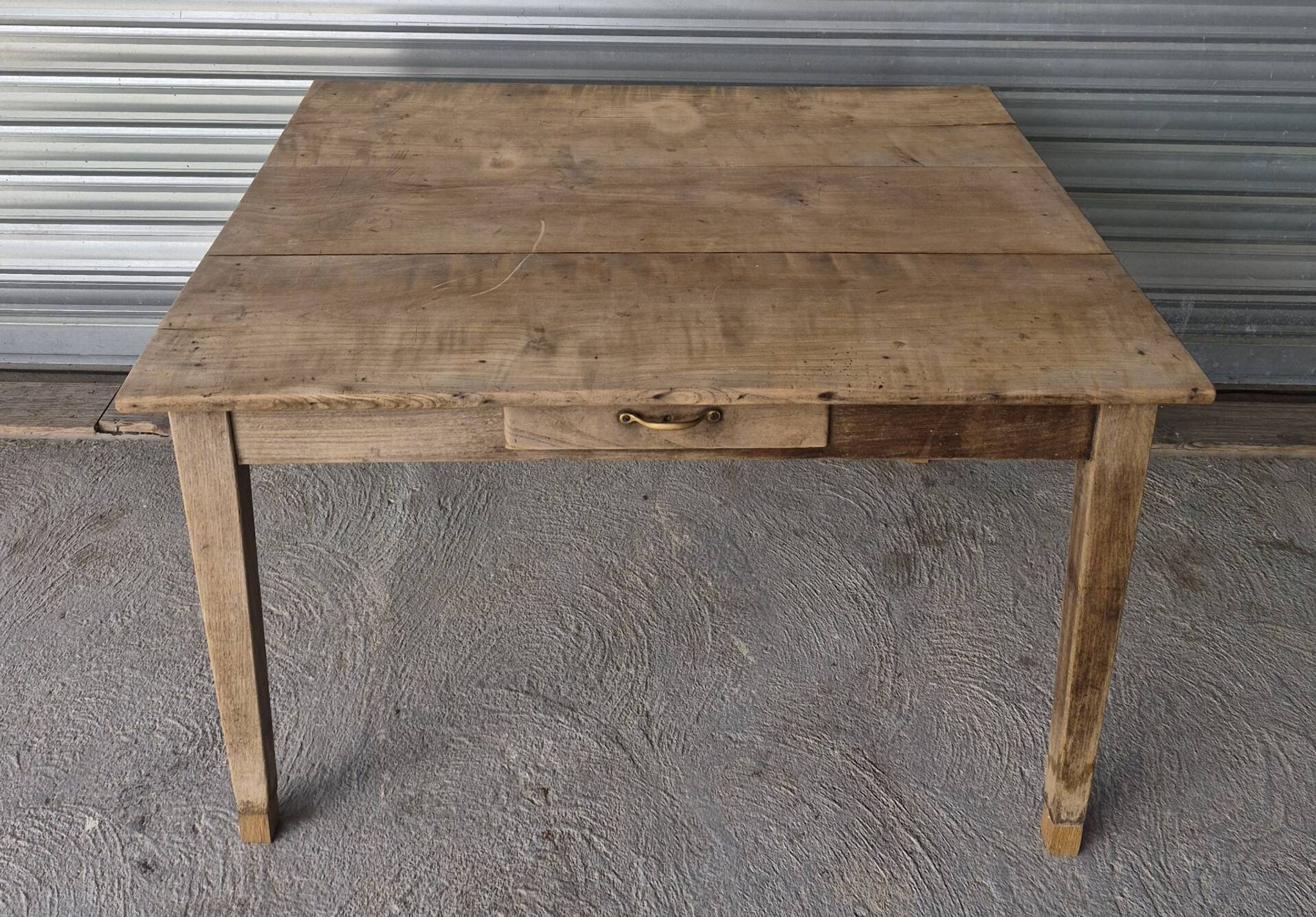 Old farmhouse table with its 2 extensions and raised legs.
