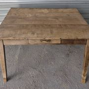 Old farmhouse table with its 2 extensions and raised legs.
