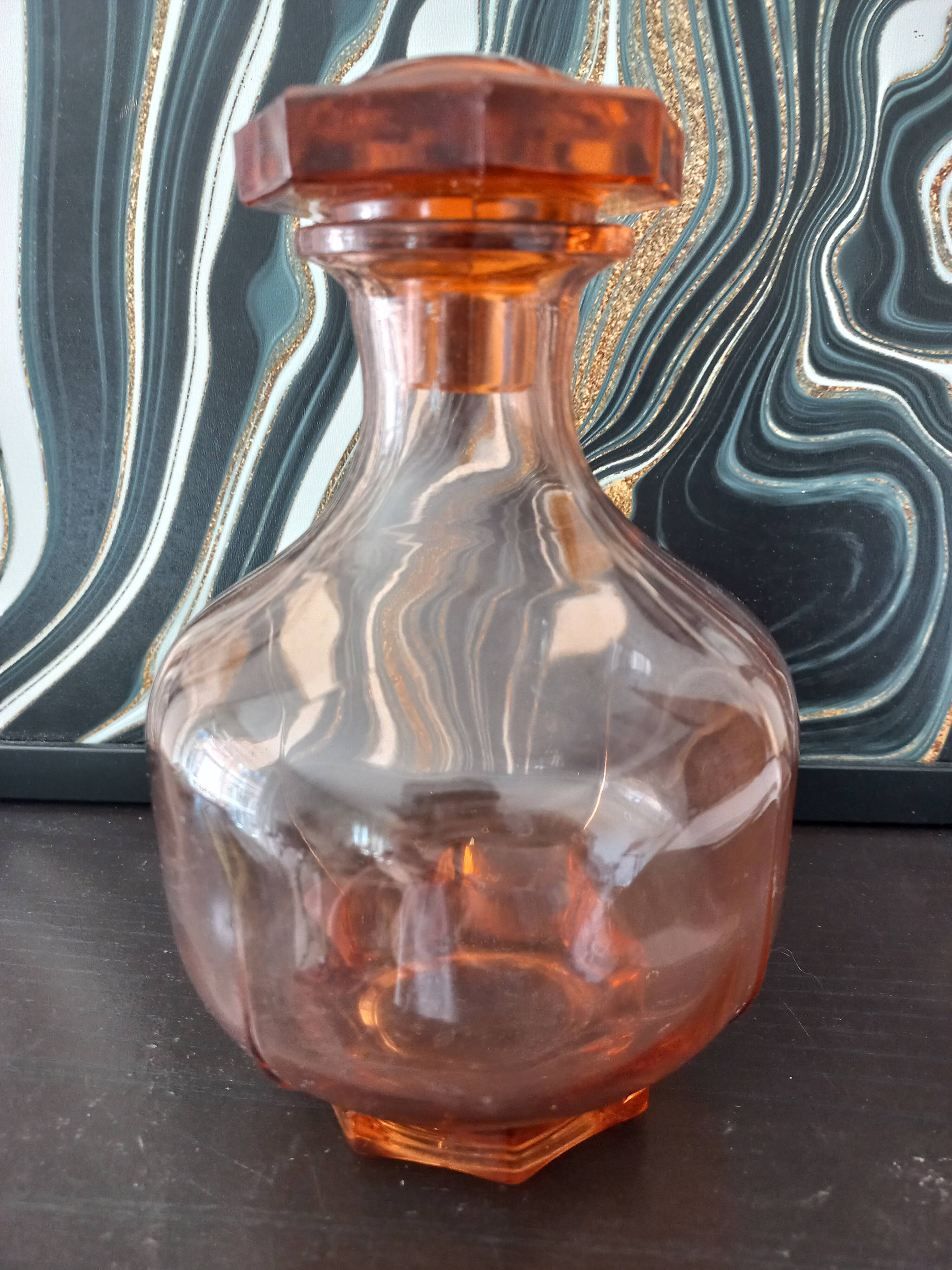 Vintage glass carafe in pink-orange, retro-chic style.