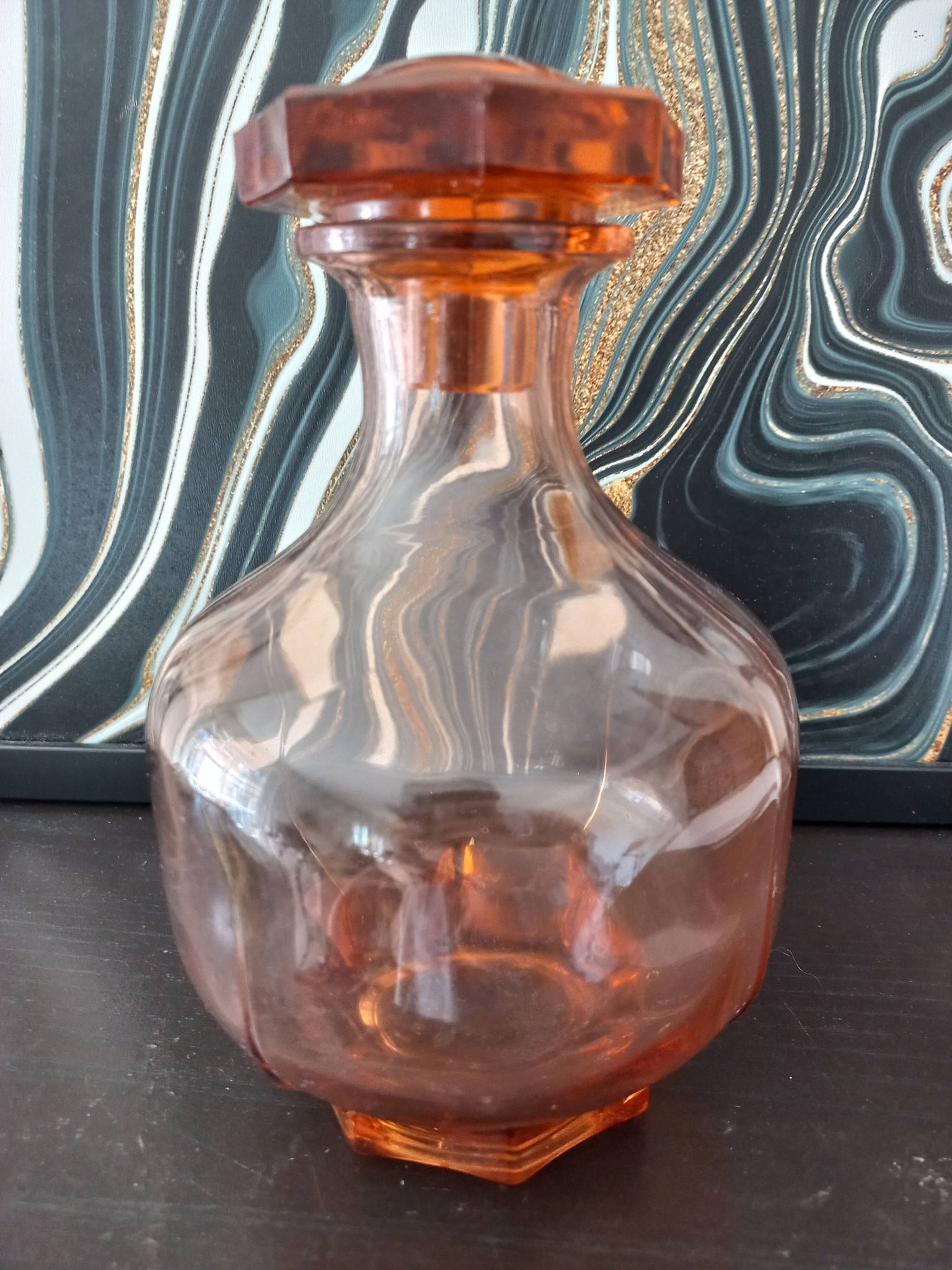 Vintage glass carafe in pink-orange, retro-chic style.