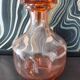 Vintage glass carafe in pink-orange, retro-chic style.
