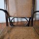Curved wooden rocking chair with caning