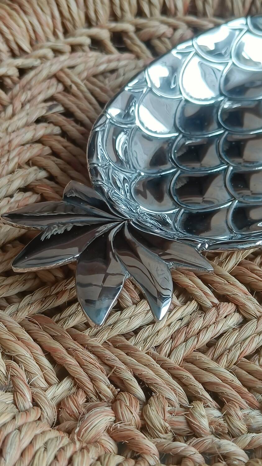 Silver-plated metal tray in the shape of a pineapple.