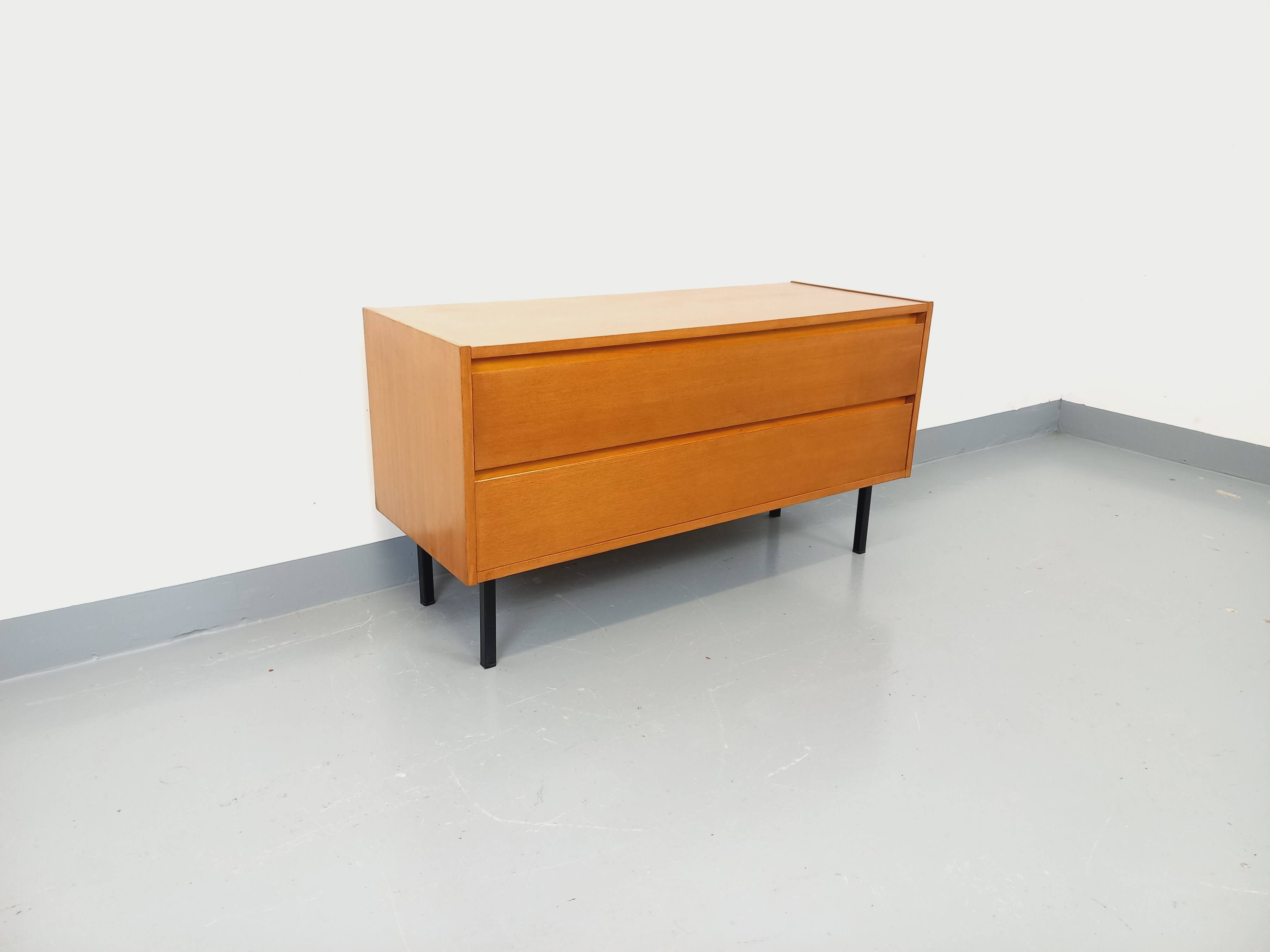 Small vintage Scandinavian sideboard in modernist style made of light oak wood.