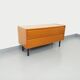 Small vintage Scandinavian sideboard in modernist style made of light oak wood.