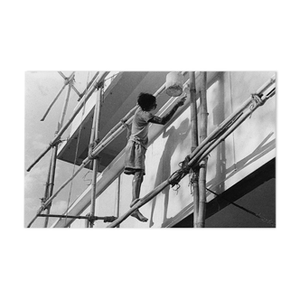 Young Indian perched on a scaffolding