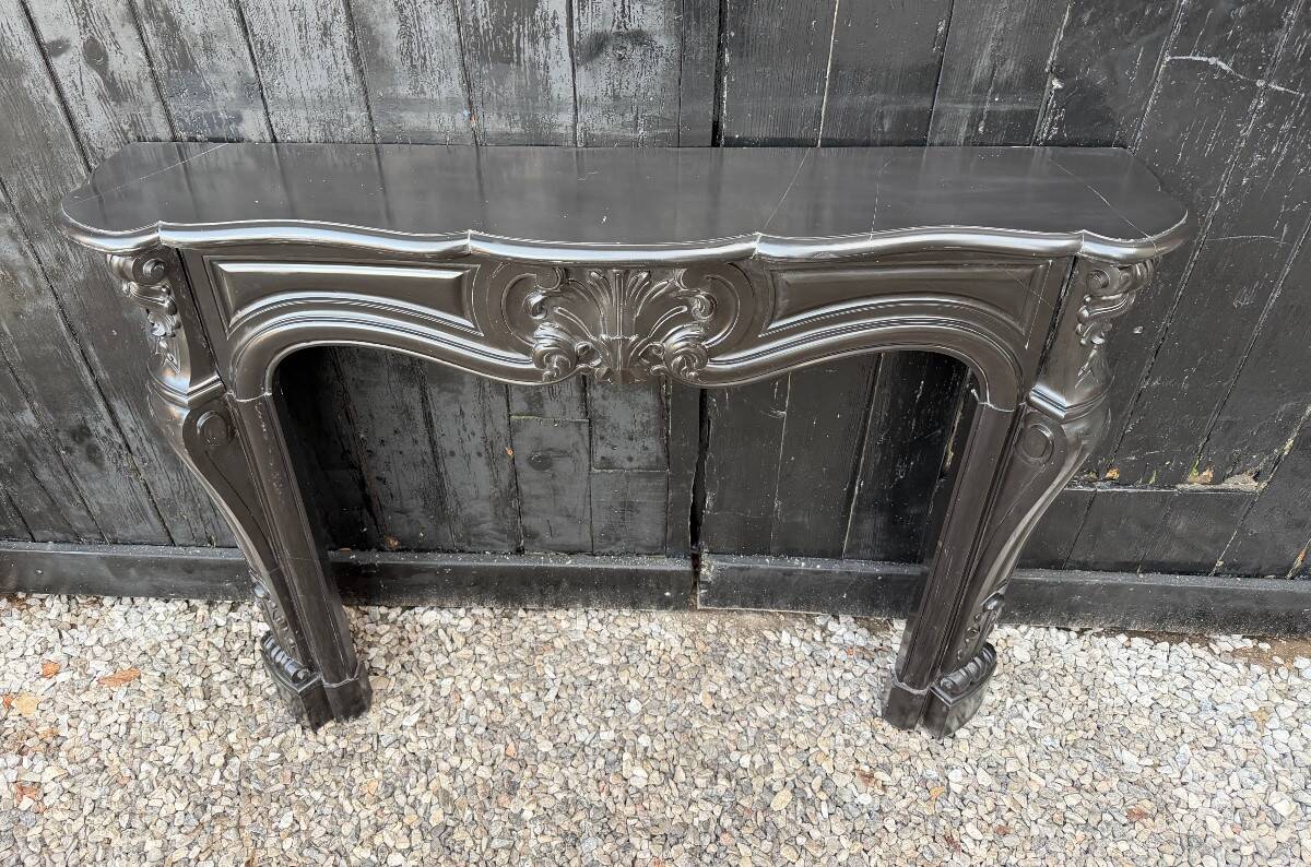 Louis XV style fireplace in black Belgian marble, circa 1880.