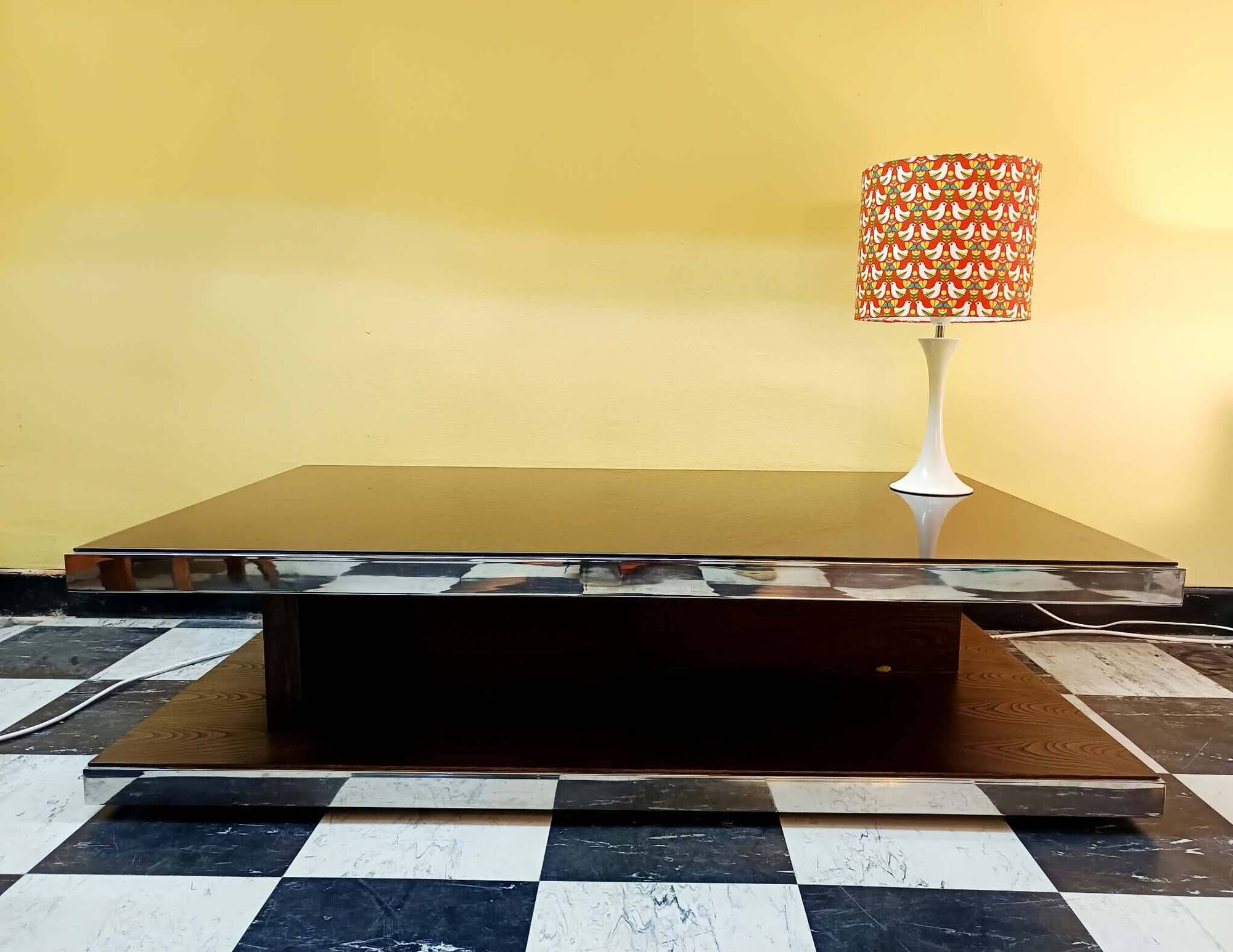 Designer coffee table in glass and chrome metal.