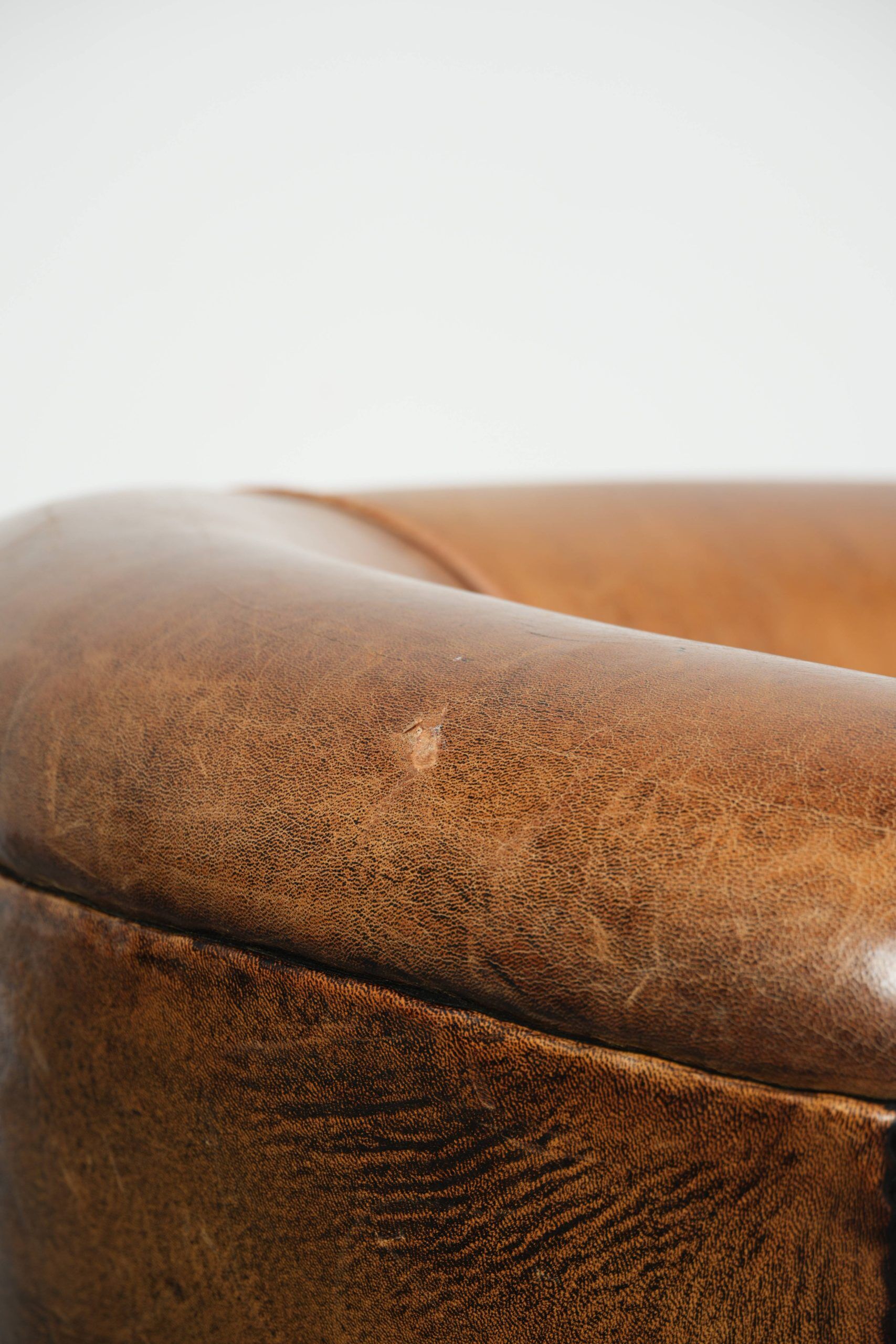 Vintage sheepskin club armchair in a subtle size with warm colours