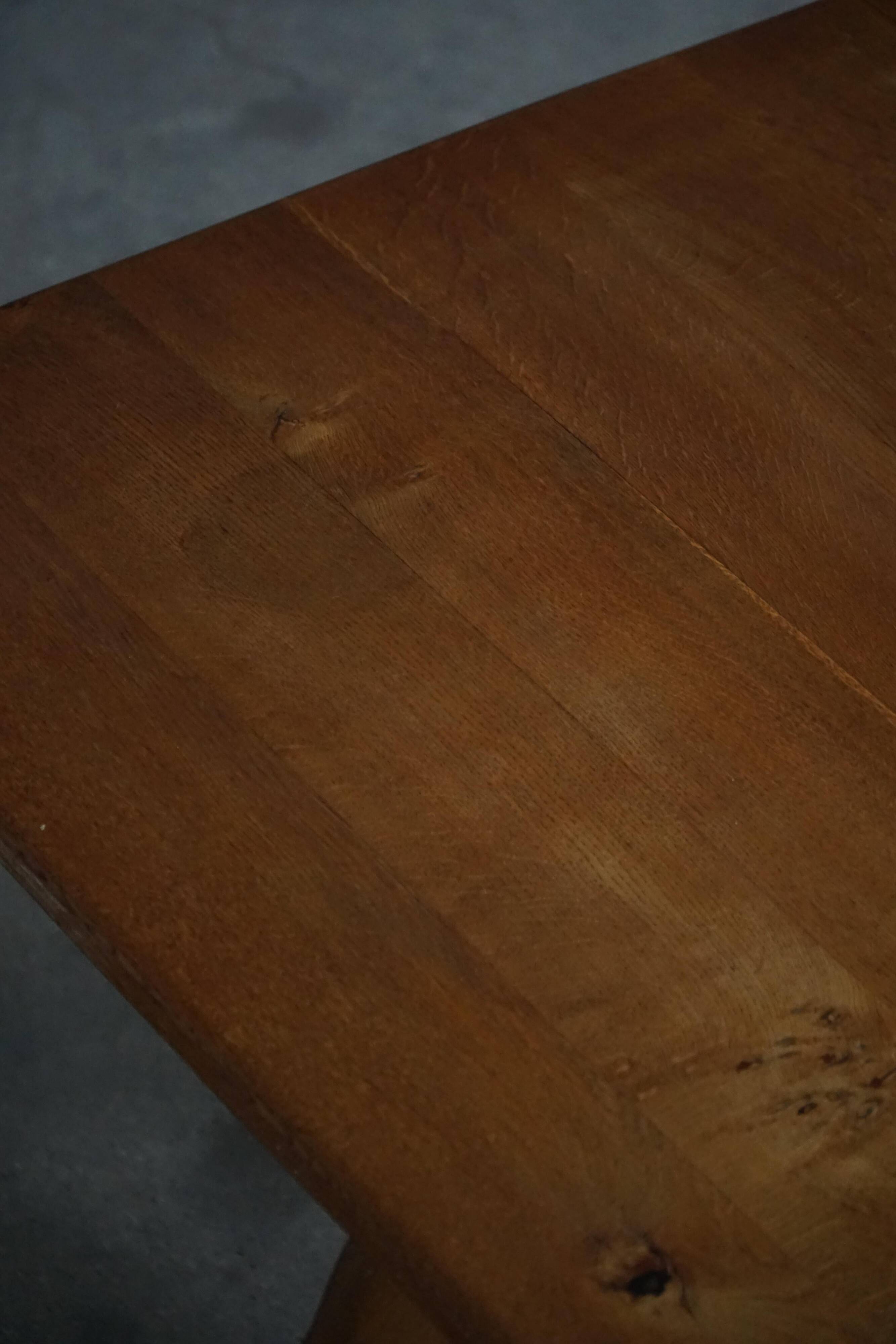 Solid oak dining table with cross base by Danish cabinetmaker, mid-20th century.