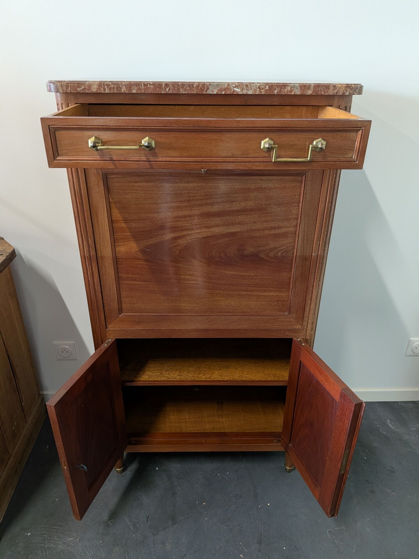 Secretary with a drop-leaf in Louis XVI style made of mahogany and royal red marble.
