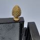 Wrought iron wire fenced fire with brass pine cone