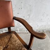 Brutalist dark brown solid wood armchair with natural rattan seat and cognac leather back