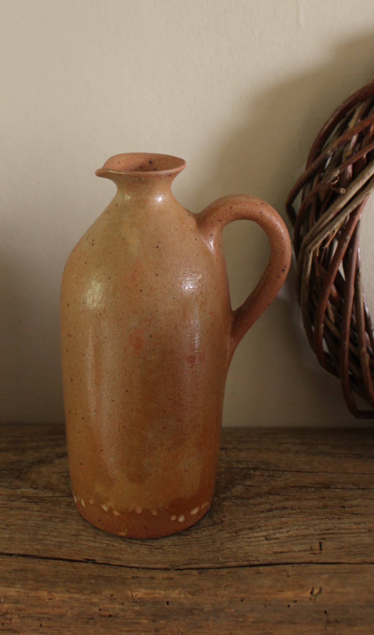 Vintage stoneware liqueur bottle with handle