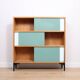 A vintage mid-century 3 tiered bookcase with glass sliding doors