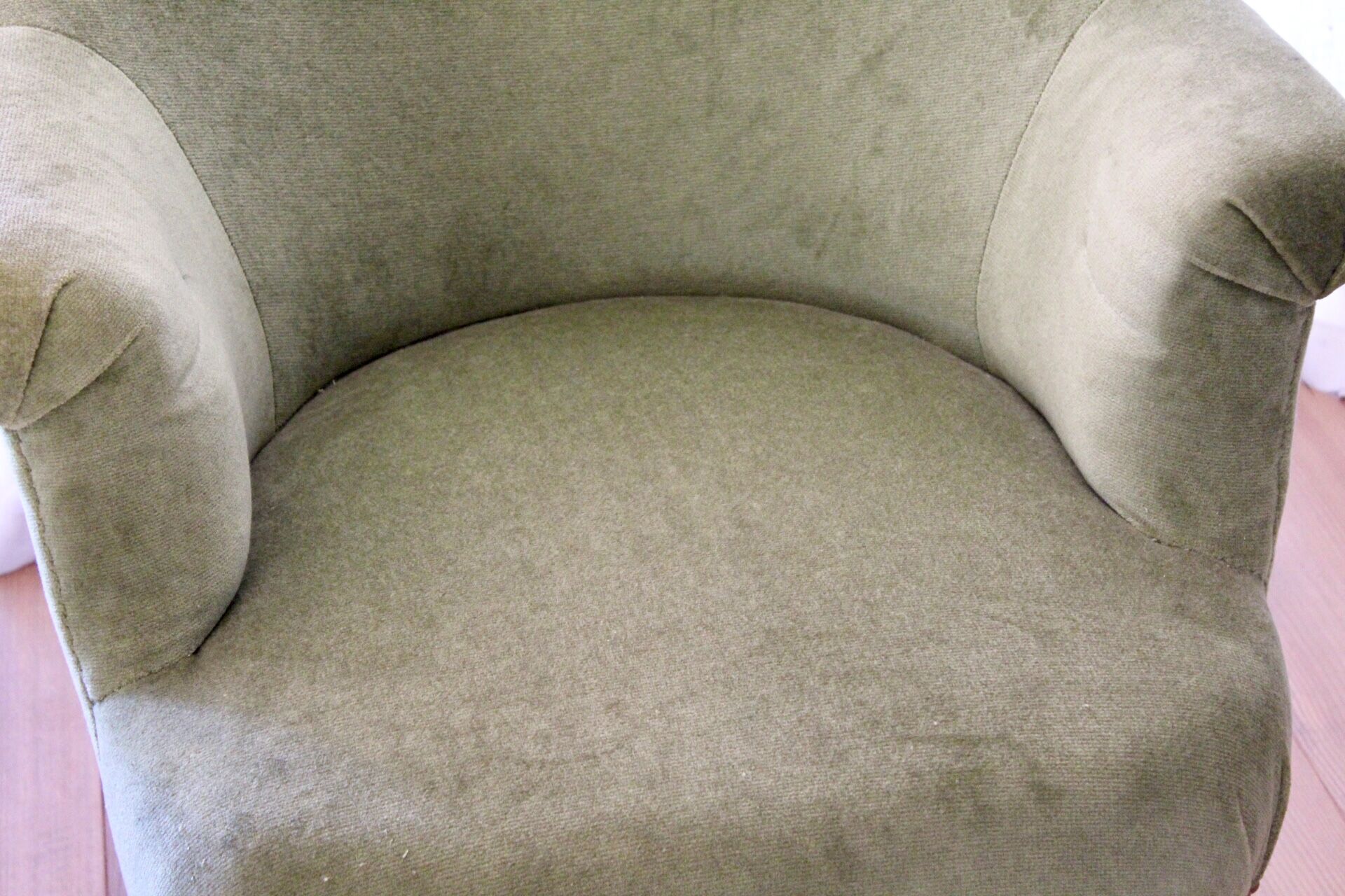 Toad in almond green velvet armchair on castors