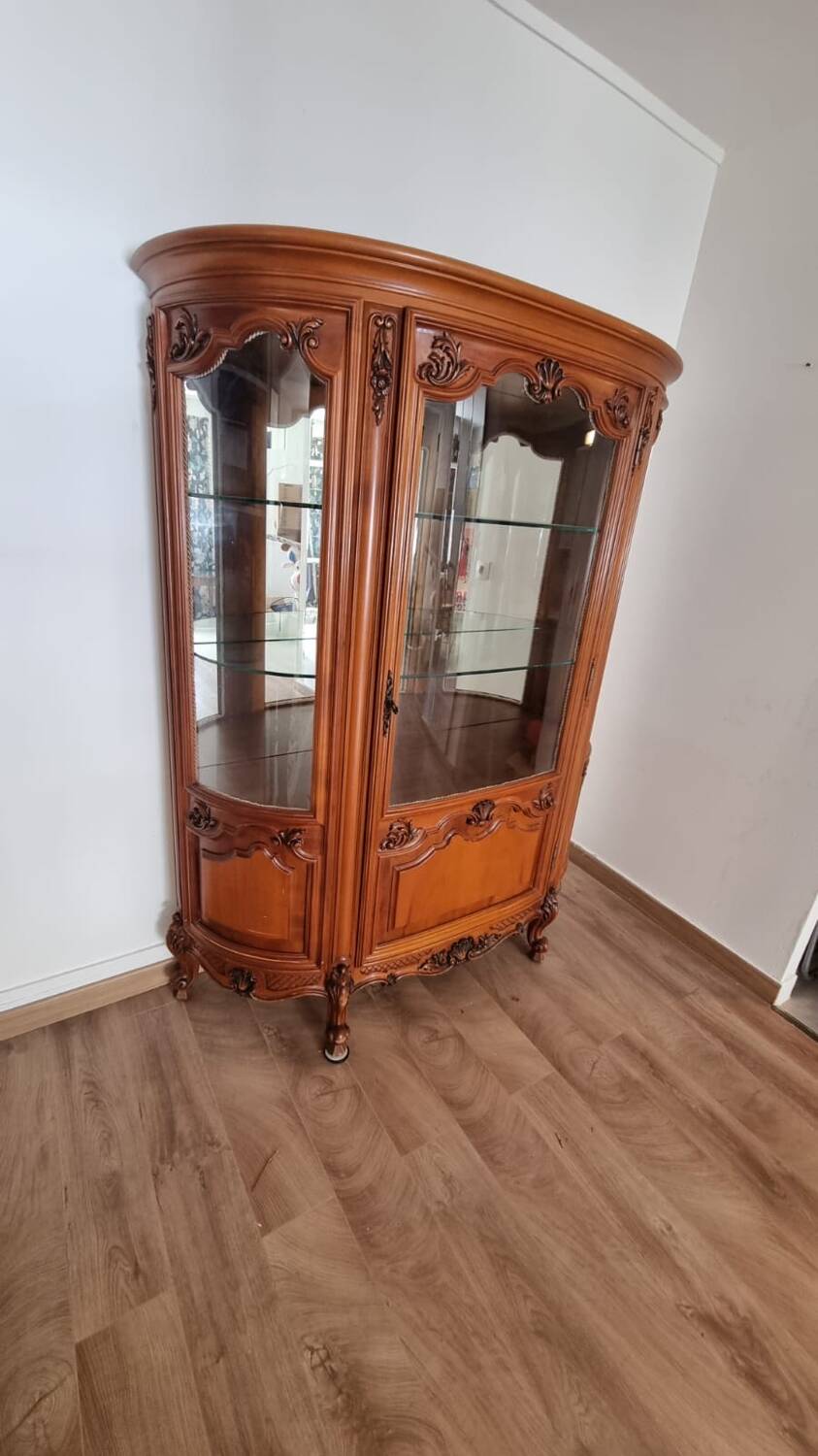 Silver display cabinet with a curved design.
