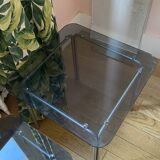pair of smoked glass nesting tables