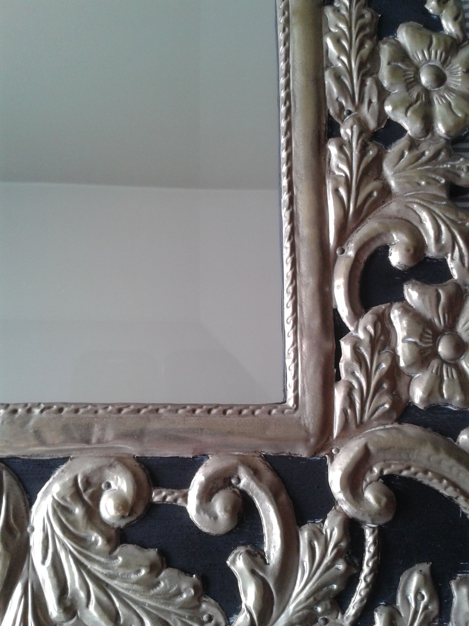 Mirror with embossed metal décor