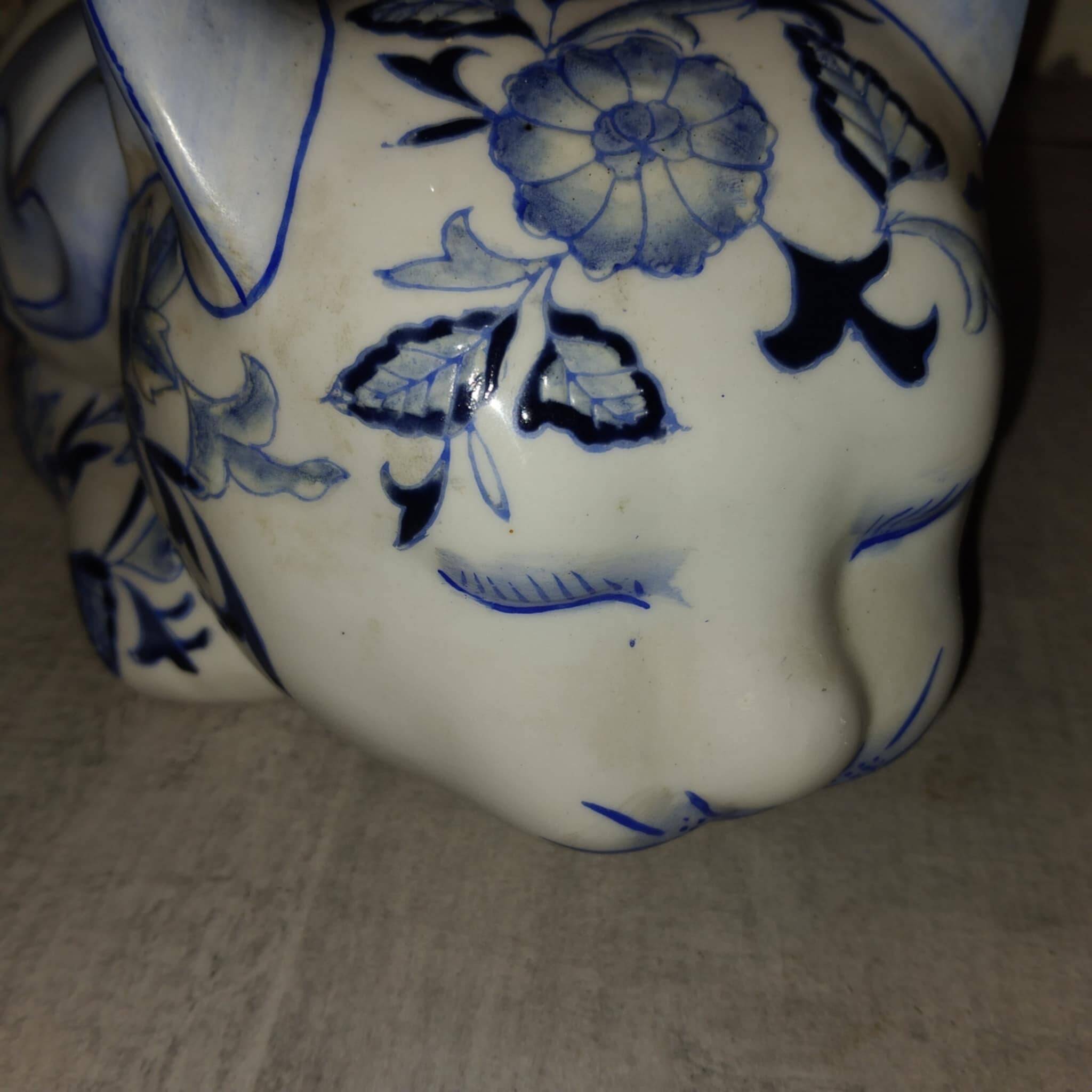 Vintage white and blue porcelain lying cat