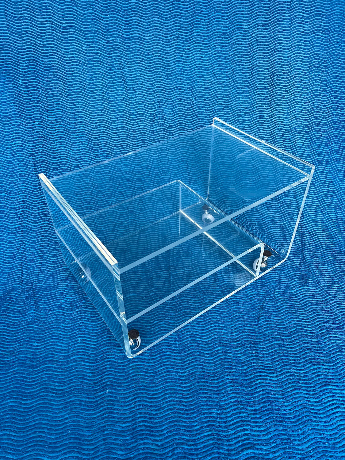 Translucent plexiglass storage drawer/cabinet on wheels.