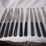 Set of 11 black wooden sleeve knives