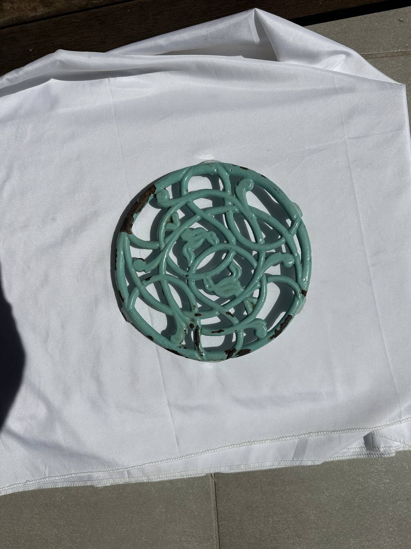 Enamelled cast iron trivet in blue with wrought iron decoration.