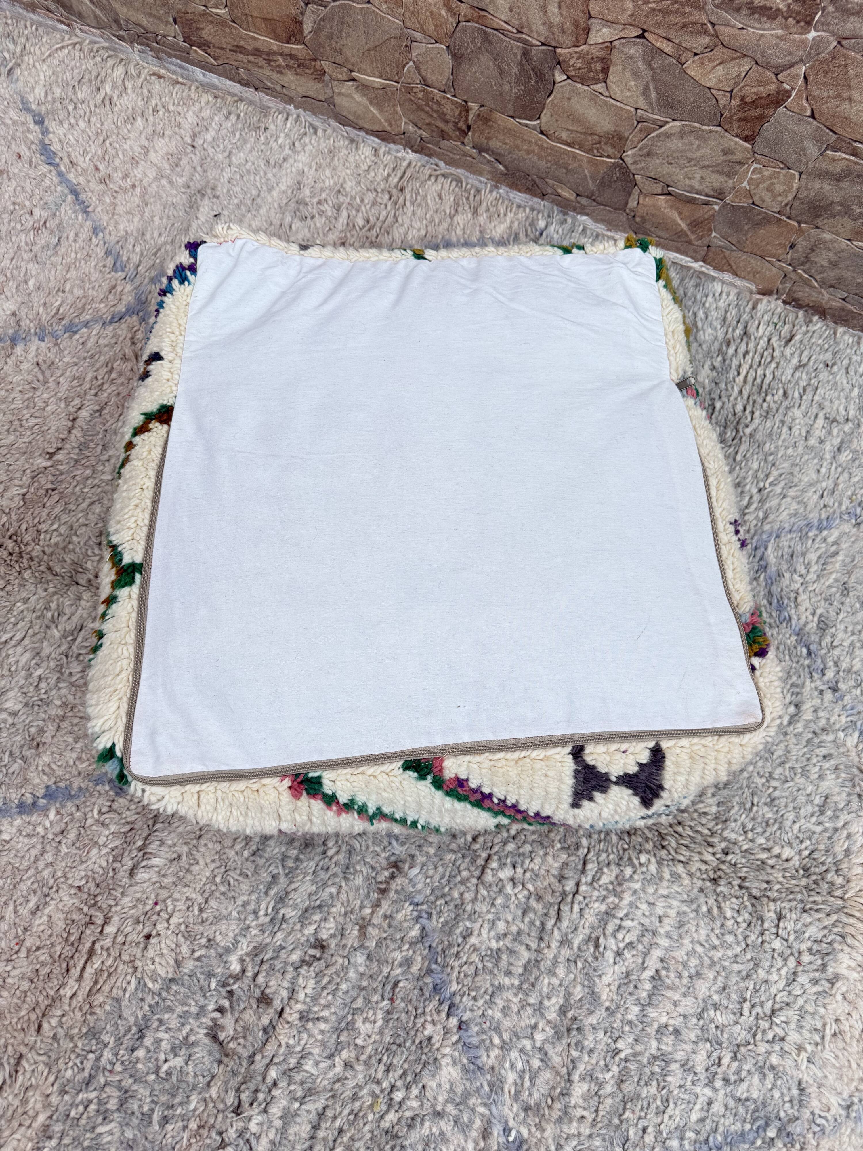 Berber floor pouf: Handwoven Moroccan wool cushion.