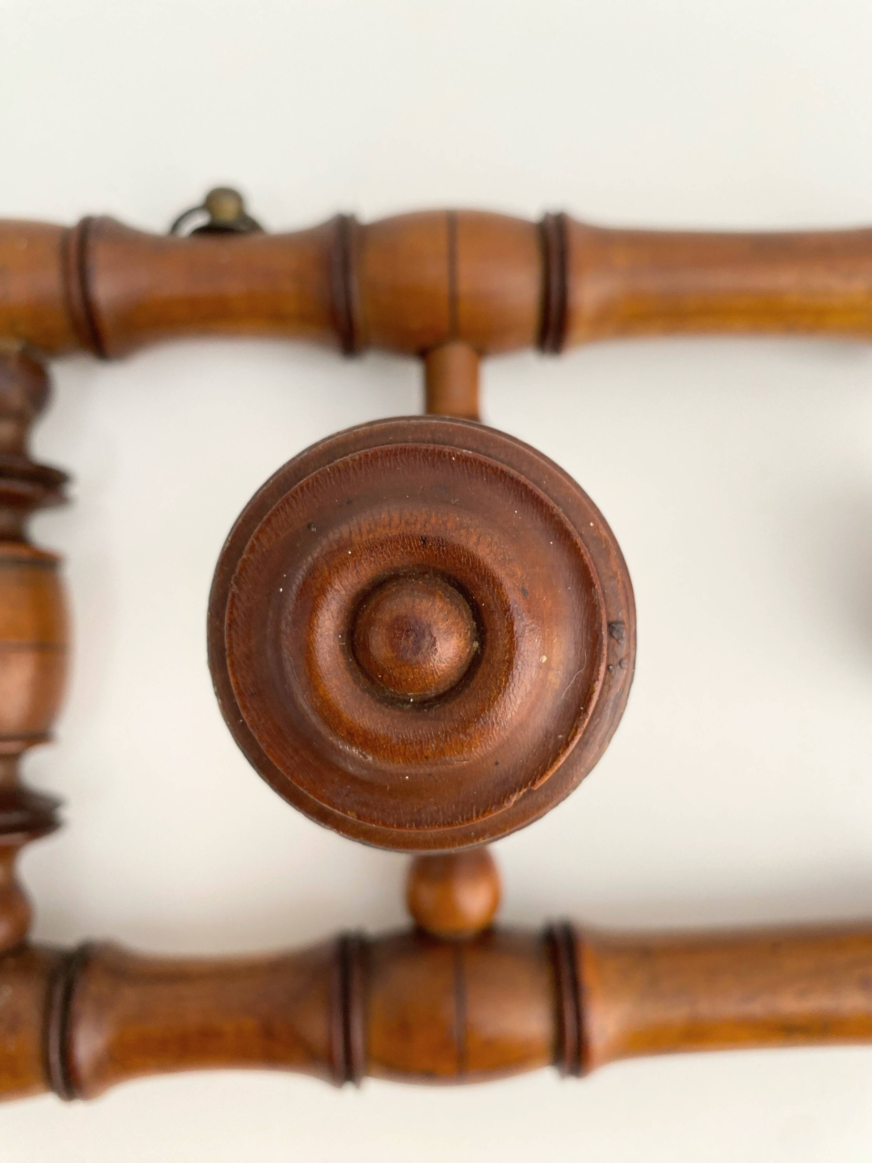 Vintage wooden wall coat rack with 4 swivel hooks from 1920