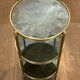 Round bronze side table with triple shelves of églomisé mirrors from Maison Baguès