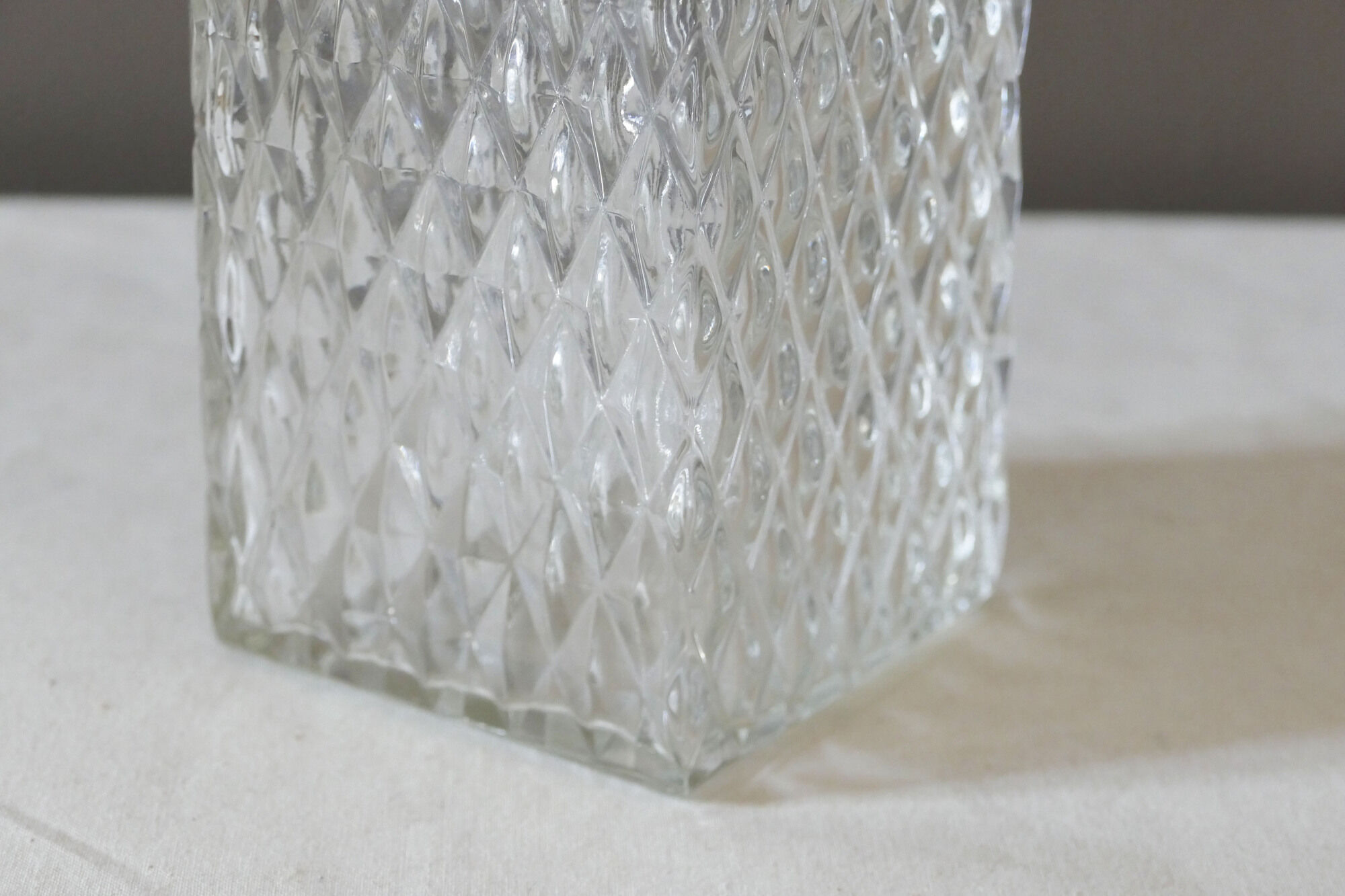 Transparent vintage decanter in chiseled glass and its hermetic cap 70's years