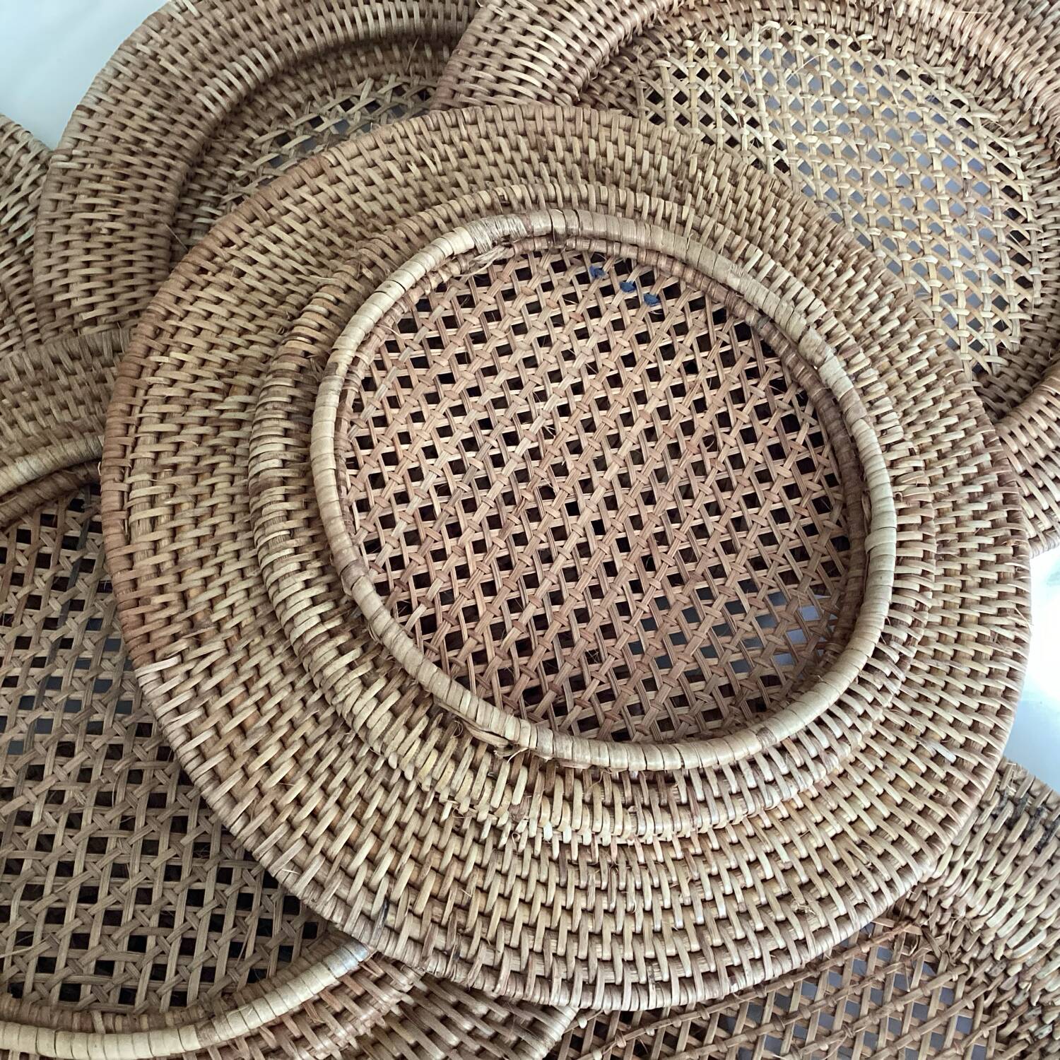 Set of round woven rattan and canework coasters
