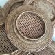 Set of round woven rattan and canework coasters