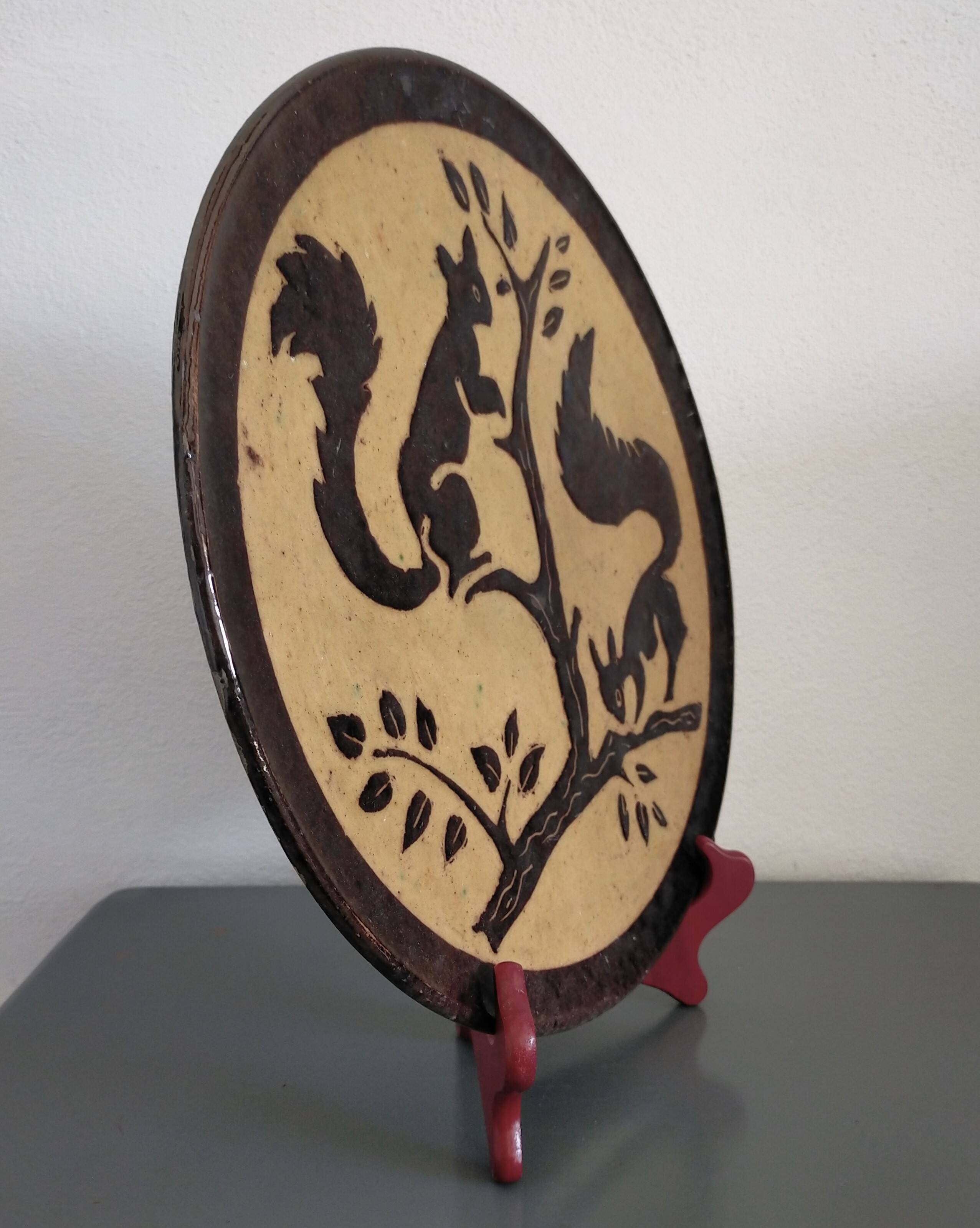 Dauphinois plate in glazed terracotta from the 1950s by Claude Faure, featuring squirrels.