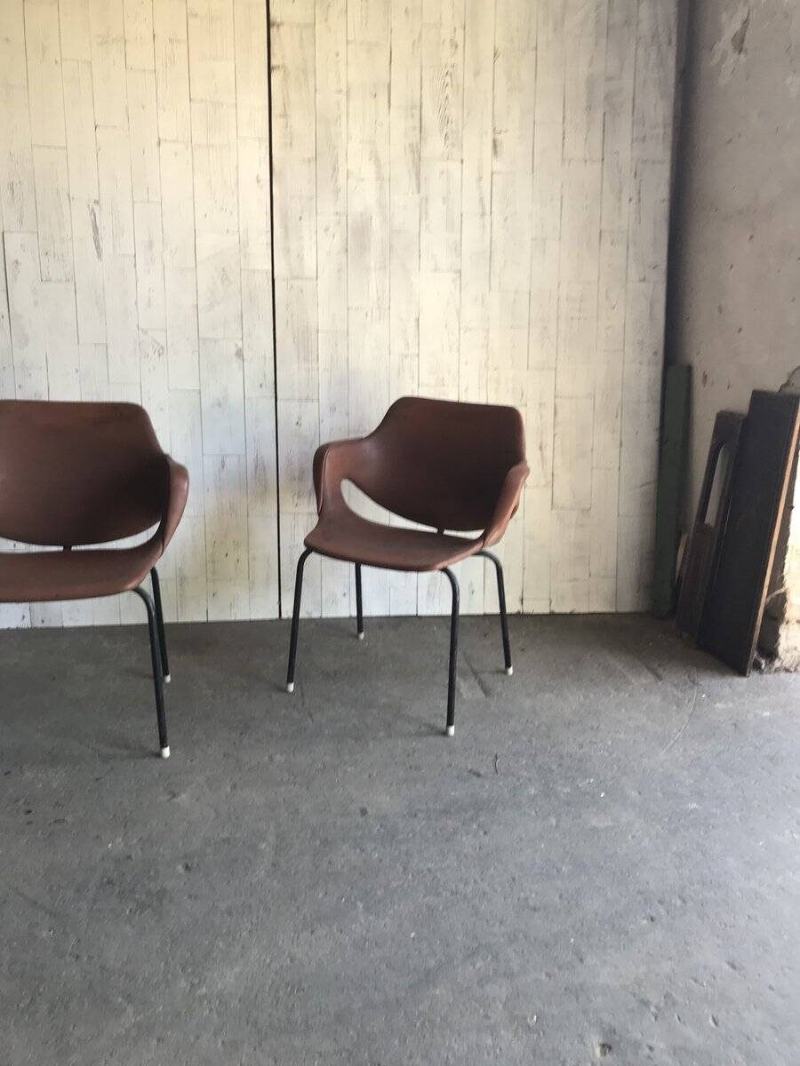 Set of 2 mid-century brown faux leather armchairs with black metal legs, 1960s.