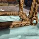 Large closed mirror, 19th century, wood and gilded stucco.