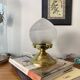 Antique globe table lamp in glass, Holophane type, and brass.