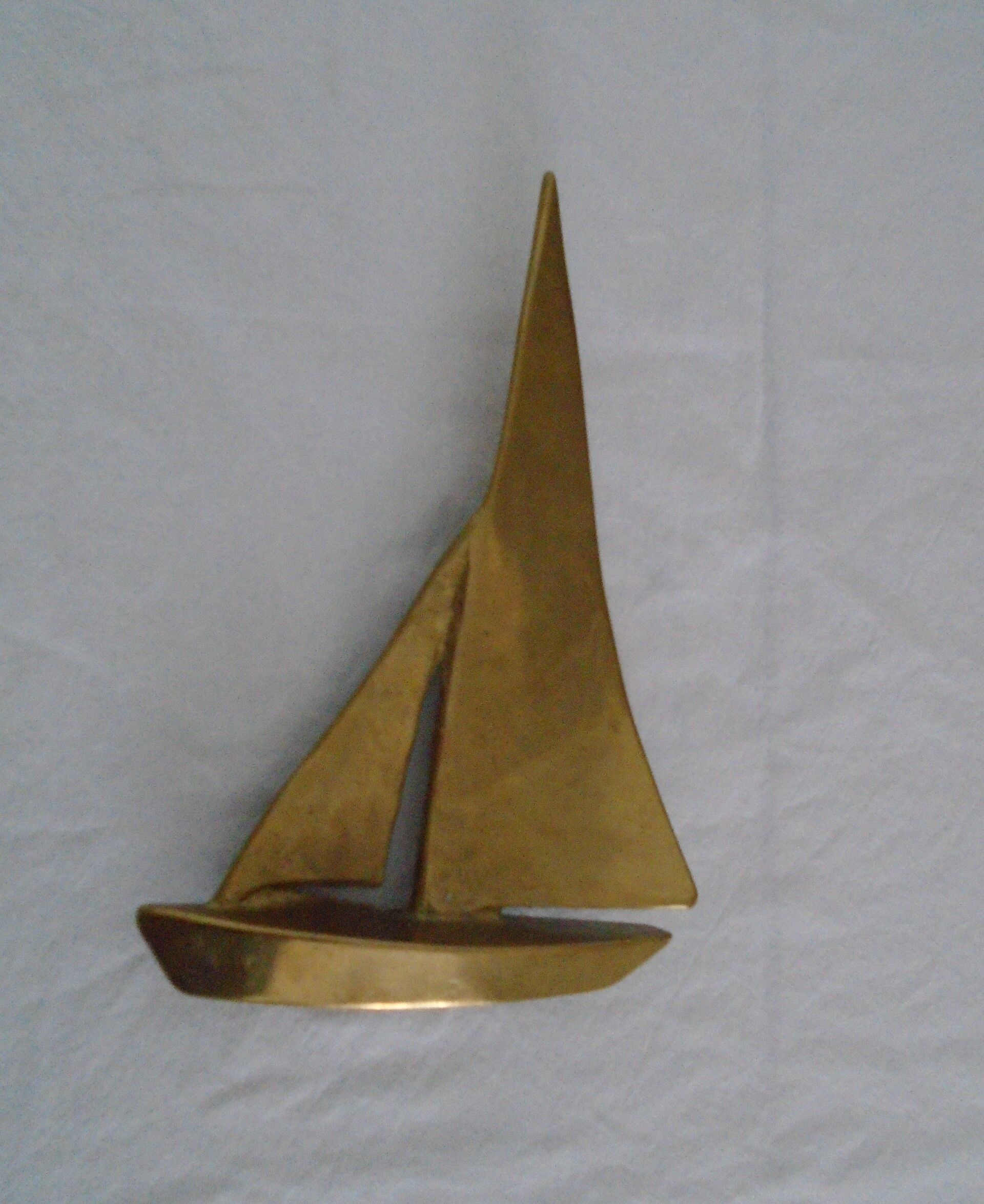 Stylized boat in brass decoration seaside